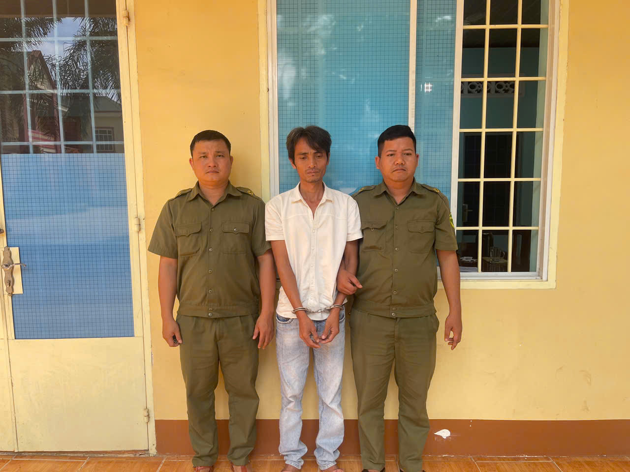 'Description: A group of men standing in front of a yellow wall

AI-generated content may be incorrect.'