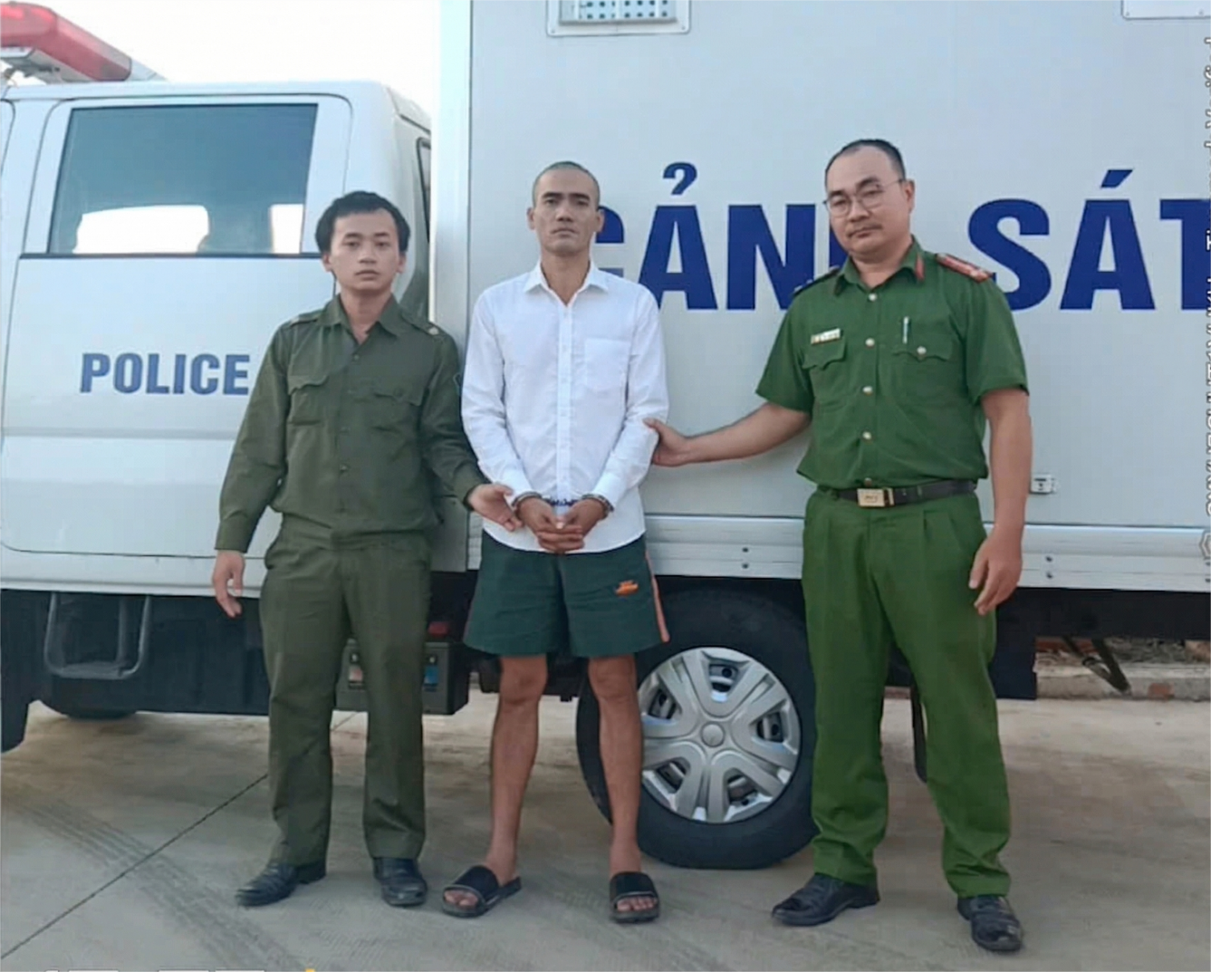 'Description: A group of men in uniform standing in front of a white van

AI-generated content may be incorrect.'